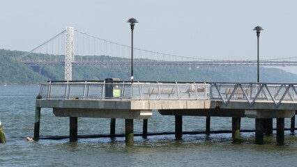 Obraz premium George Washington bridge, Hudson river in New York City, United States of America. Transport bridge architecture, riverside park pier in West Harlem. Waterfront promenade near river water. USA nature.