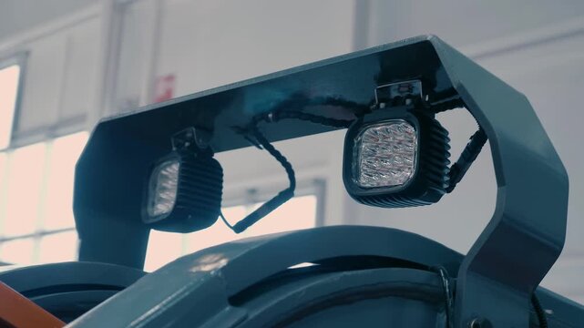 Powerful square LED lights on construction equipment that operates in hard conditions and requires high lighting. Closeup. Shot in motion 