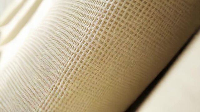 Beige woven fabric creating an organic textile texture, presenting a detailed view of its intricate pattern and soft neutral material for upholstery designs and backgrounds