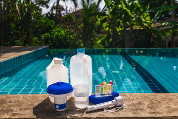 Swimming pool maintenance chemicals and water testing kit with pH and chlorine test tubes,...