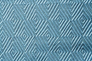 Fototapeta premium Natural light blue geometric diamond pattern quilted fabric texture closeup
