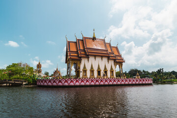 Naklejka premium Wide view of traditional Thai temple surrounded by water at Plai Laem temple Koh Samui Thailand