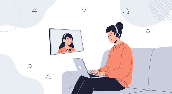 Woman on Sofa with Laptop Video Calling Friend with Headphones