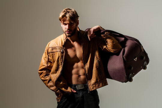 Man handsome model portrait expression. Man sexy torso muscular abs. Man dramatic light shadow contrast. Man bold stylish fashion.