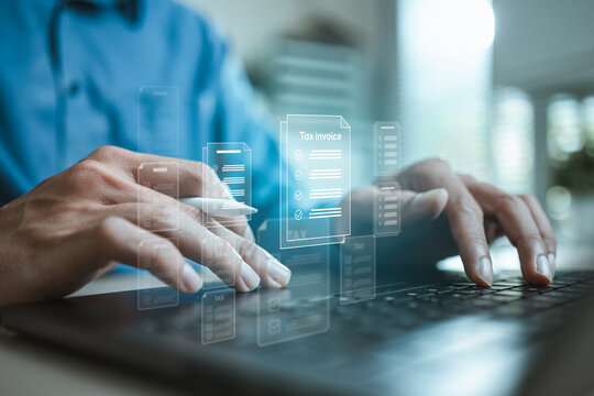 User managing digital tax invoices and financial documents on laptop, representing accounting, bookkeeping, document organization and automated financial workflows.