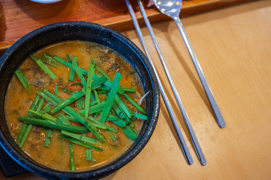 korean loach soup chueotang with chives in a traditional stone bowl