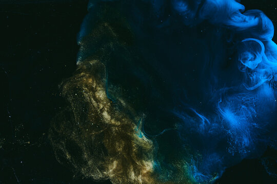 Abstract colorful blue smoke on black background. Moving flow of paints, fluid liquid art, space sky
