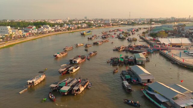 Aerial view of Cai Rang floating market, Can Tho, Vietnam. It is famous market in Mekong Delta, Vietnam. Tourists have breakfast on a boats, buy and sell food, vegetable, fruits on boat, ship