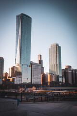 Fototapeta premium Chicago Skyline With Modern Glass Skyscrapers at Golden Hour Over Riverfront and Urban Waterfront