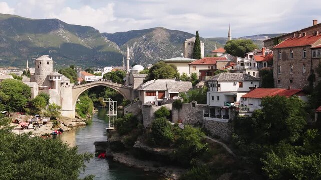 iew of city and ancient arched stone bridge over Neretva river. Legacy of Ottoman architecture in Balkans 
