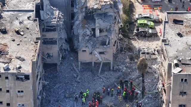 Aerial view Holon Iranian missile strike destruction Israel

Drone footage showing rescue teams at missile impact site in Holon residential area Israel June 14 2025
