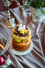 Naklejka premium Celebrate spring with a delightful cake topped with chocolate and colorful candies at a festive table setting