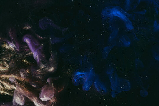Abstract colorful blue smoke on black background. Moving flow of paints, fluid liquid art, space sky