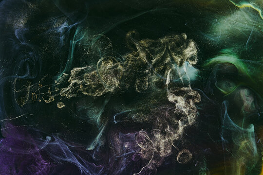 Abstract colorful green smoke on black background. Moving flow of paints, fluid liquid art, space sky