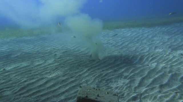 Slow camera approach to an active underwater outfall pipe discharging wastewater into the ocean over a Cymodocea nodosa meadow