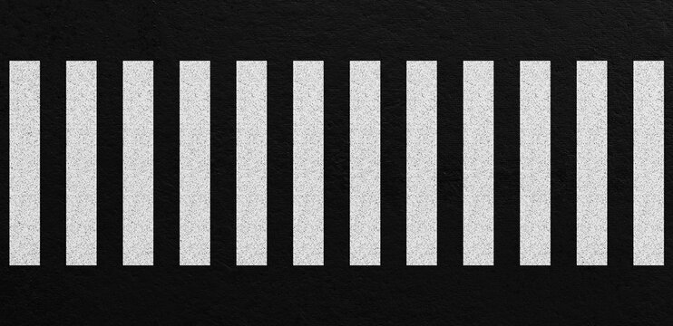 Top view of zebra crosswalk with white pedestrian stripes on dark asphalt road surface