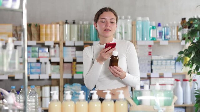 Female buyer scans code on cough syrup to check the expiration date. High quality 4k footage
