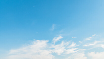 Fototapeta premium the sky is clear blue with fluffy white clouds, the sky is very bright, and the sun shines