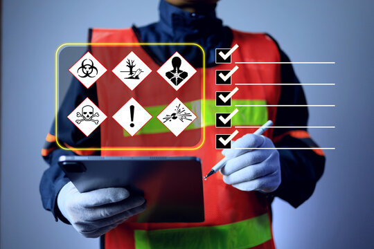 industrial worker in a high-visibility safety vest using tablet to perform chemical hazard safety inspection hazard safety checklist, workplace compliance, risk management and occupational health