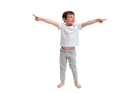 Little boy in white t-shirt pointing with both hands in opposite directions. Smiling child showing way, making choice or decision. Isolated full length studio shot on transparent background.