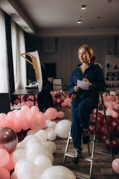 Event planner woman organizing party balloons decoration