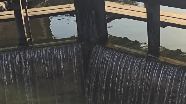 Locked-down video of the Grand Canal Lock, canal flowing closeup.