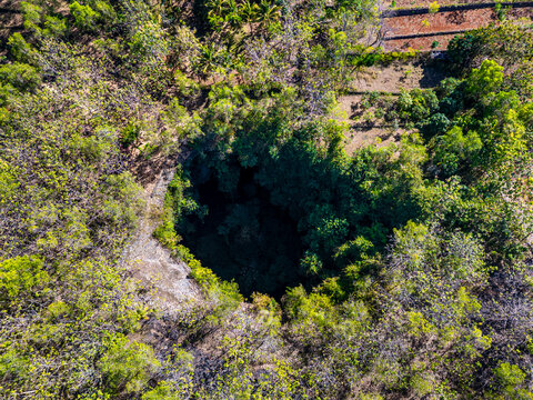Jomblang cave in Gunungkidul is a doline formed by a cave collapse a large, natural sinkhole with steep edges surrounded by trees. Geological formations and natural land changes, drone view, aerial