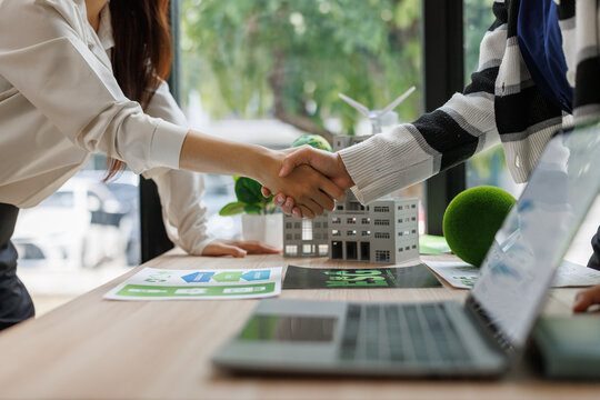 Business people shaking hands over sustainable development project