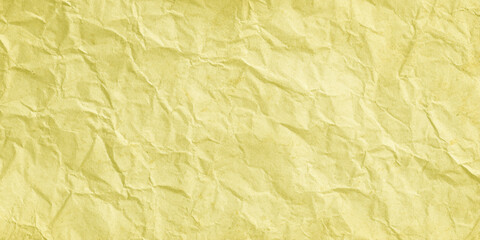 Fototapeta premium Crumpled yellow paper texture background with creases and wrinkles for design and craft projects