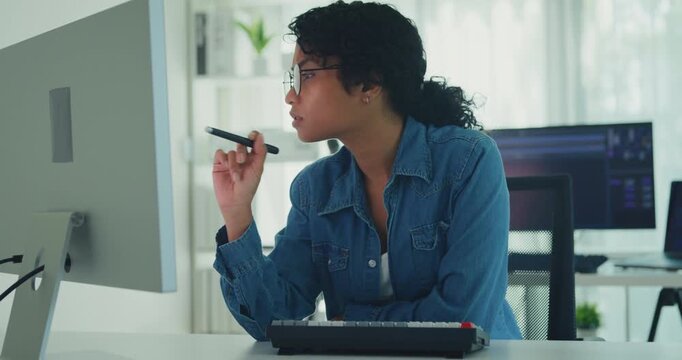 Young professional African American female programmer coding AI software on screens in modern home office. Generative AI, machine learning, digital innovation, future technology, online job concept.