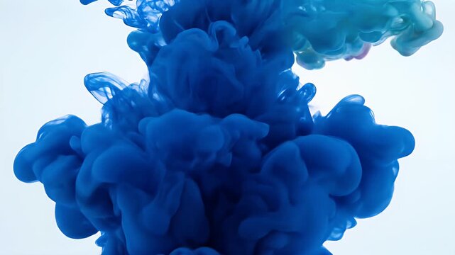 Blue Ink Cloud in Water - A vibrant cloud of blue ink swirls and diffuses in water, creating an abstract and mesmerizing effect.