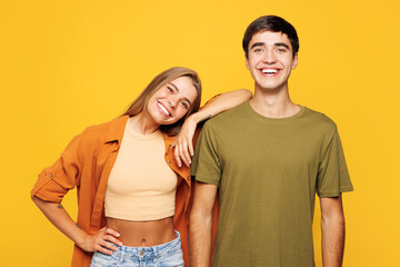 Fototapeta premium Young calm couple two friends family man woman wears shirt casual clothes together put head on shoulder look camera isolated on pastel plain light yellow background studio portrait. Lifestyle concept.