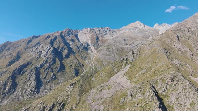 Cinematic drone orbit around steep, rugged mountain ridges in Kinnaur Valley, ChitkulHimalayas