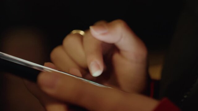 Closeup young hands rapid tapping screen with bright glow, quick swipes and multifinger presses, notifications flashing, urban night energy and concentrated focus, candid mobile use, roles include