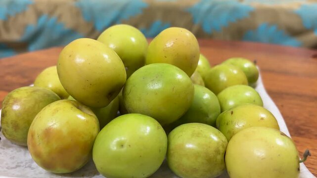 fresh green and yellow ber fruit close up in bowl on wooden table healthy indian jujube fruit
