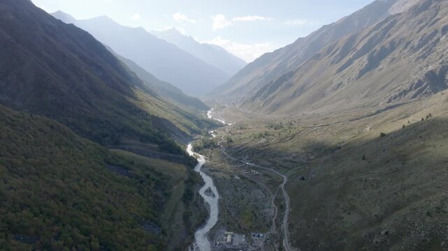 Aerial Drone pullback reveal wide landscape of Baspa River, mountains in Chitkul, Kinnaur valley, Himachal Pradesh.