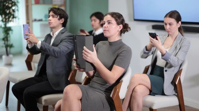 Specialists take pictures of the presentation on mobile phone and tab during business training. Corporate education in modern office and work with information. High quality 4k footage