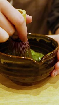 Traditional Japanese Tea Ceremony Hands Whisking Matcha Green Tea in Bowl