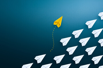Naklejka premium Group of paper plane in one direction and with one yellow paper plane individual pointing in the different way. Business concept for new ideas creativity and innovative solution.