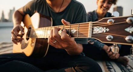 Obraz premium Young Hispanic Man Playing Acoustic Guitar for Friend on Urban Rooftop at Sunset