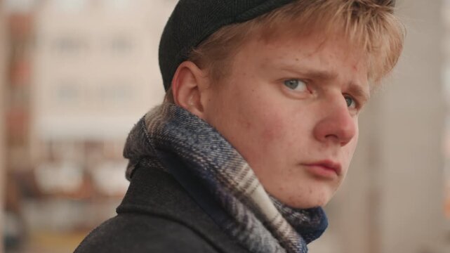 Creator on city porch, determined gaze and steady posture, indie director energy, scarf and beanie details, urban backdrop with blurred traffic, cinematic tension and narrative moment