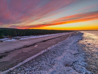 Beautiful sunset over the frozen Baltic Sea beach in Jantar, Poland