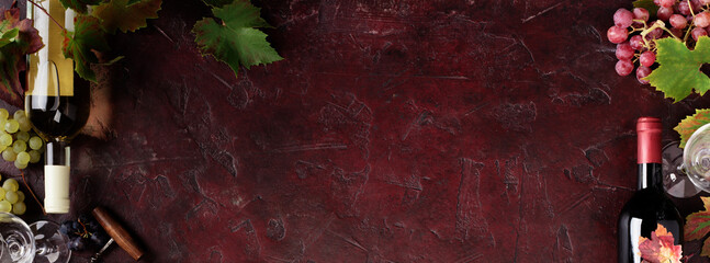 Fototapeta premium Red Wine Bottles and Glass with Grapevine on Rustic Background