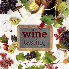 Fototapeta premium Wine Tasting Chalkboard with Grapes and Bottles Flat Lay