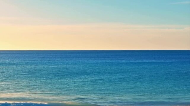 A stretch of calm blue water, with a neat horizon. On the shore, small waves lapped gently as if calming the atmosphere.