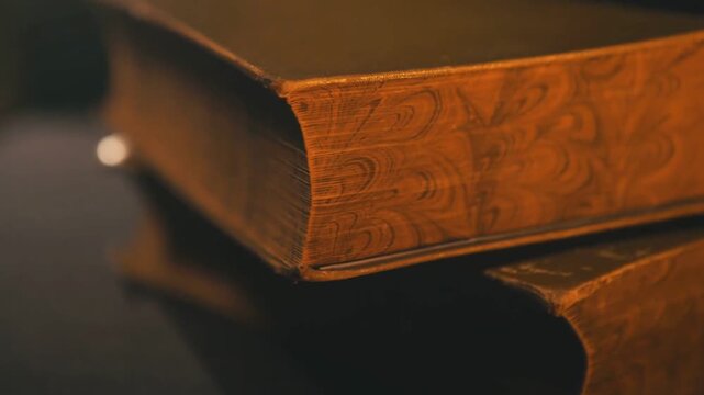 Stack of Vintage Books on Table in Dark Room Moody Light