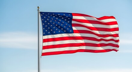 Classic USA American Flag Waving on Flagpole with Soft Blue Sky Backdrop