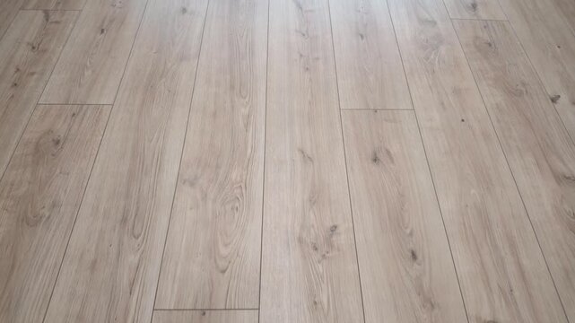 New laminate flooring. Laminated parquet with brown wooden texture