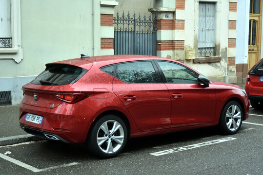 Mulhouse - France - 29 March 2026 - profile view of red Seat Leon parked in the street