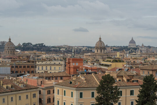 Rome skyline from Capitoline Hill with Italian pine trees and St Peter Basilica dome view